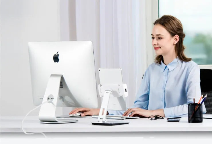 Foldable aluminium and ABS desktop stand holding a tablet at an angle.