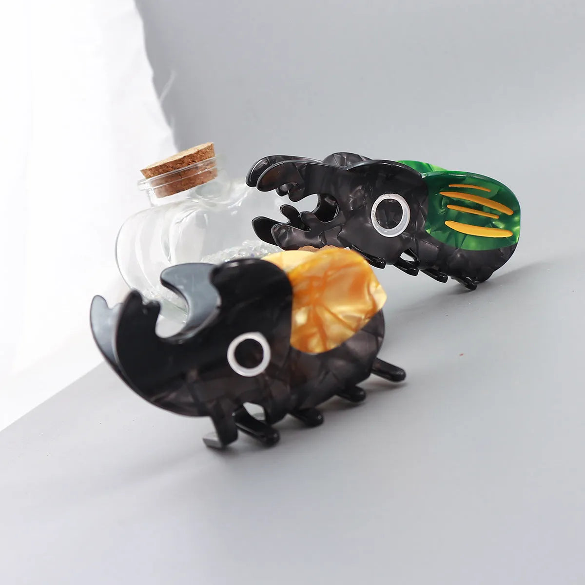 Cellulose acetate sheet Beetle Grip decorative art showing cartoon insect designs in green, orange or white.