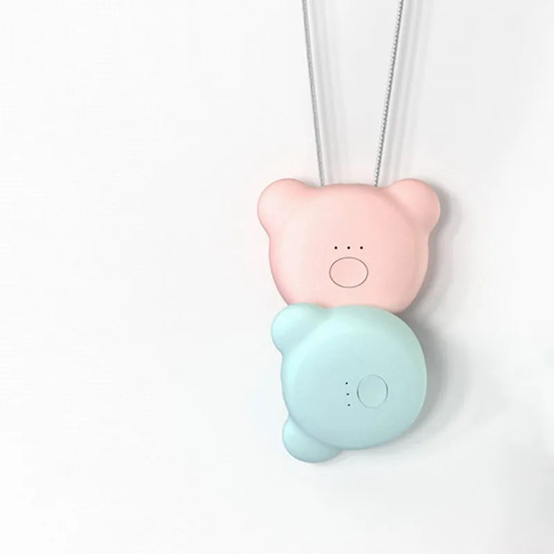 Mini USB portable air purifier necklace in pink, showing compact wearable design.