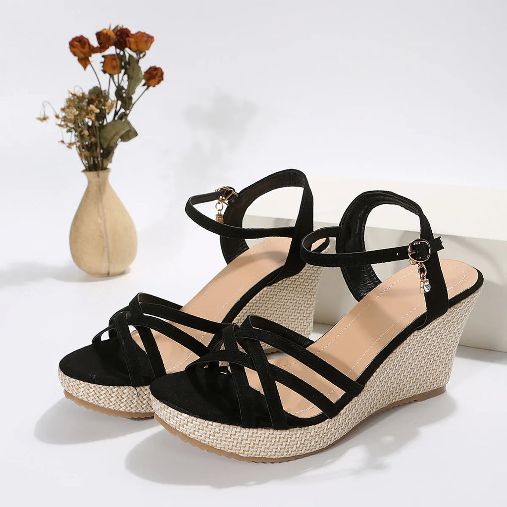 Women's beige cloth wedge sandals with a fish mouth toe design on a plain background.