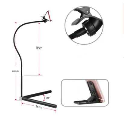 Black mobile phone bed bracket mounted on bedside with phone secured in universal folder for hands-free viewing