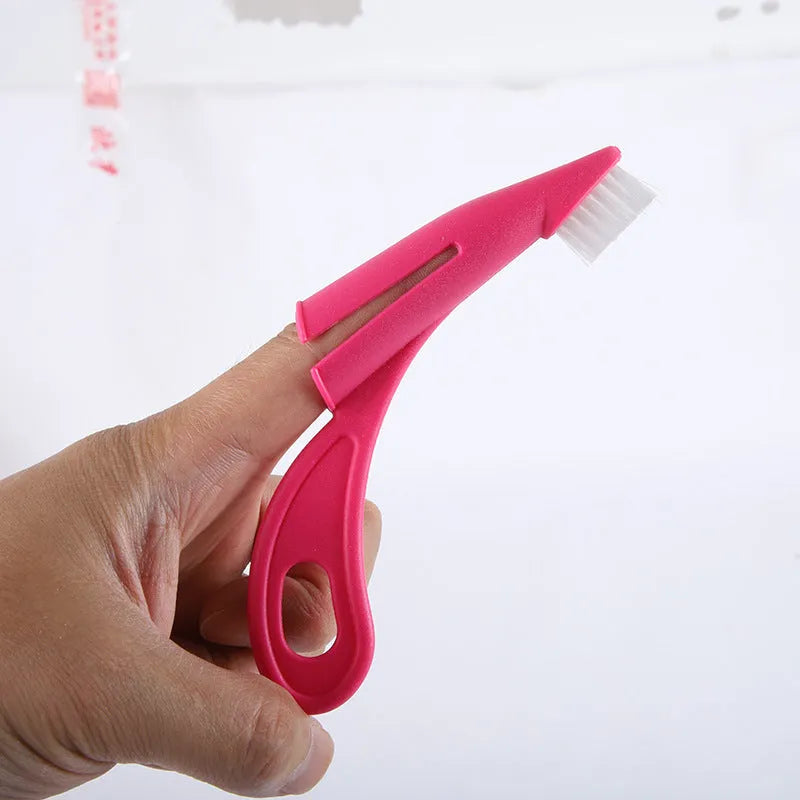 Red and white pet finger toothbrush with silicone bristles for dog and cat dental care.