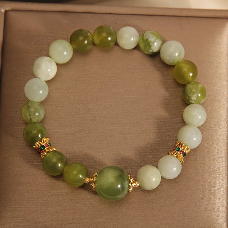 Xiuyan jade green Mori-style women's bracelet on a wrist.