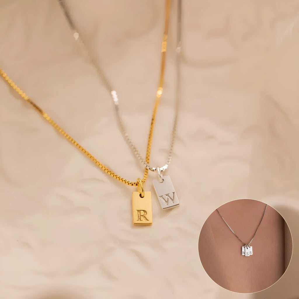 Mini square stainless steel initial necklace with gold plating on a sparkling box chain