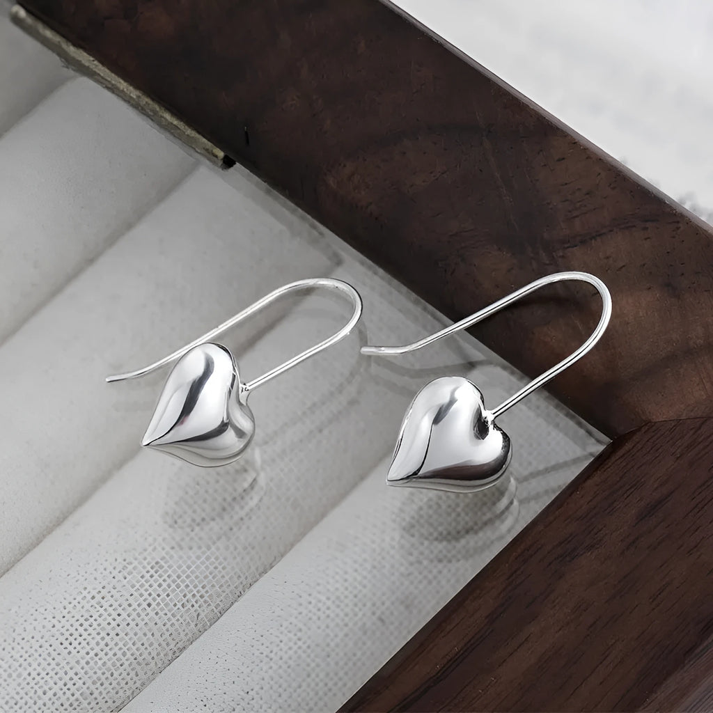 Silver heart earrings with glossy three-dimensional design and Korean style ear hooks