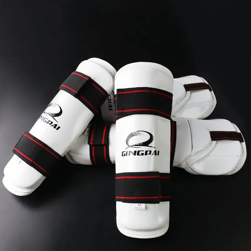 Taekwondo arm and leg protective gear set showing arm guards and leg protectors in standard sizing