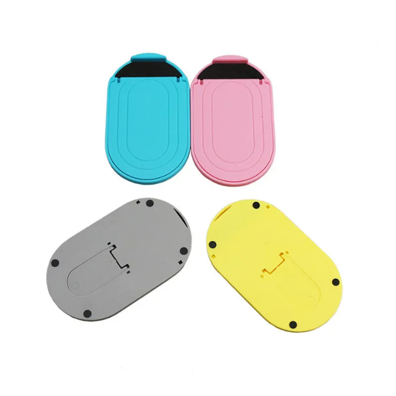 Plastic mobile phone stand with adjustable lazy bracket in six colour options on tabletop