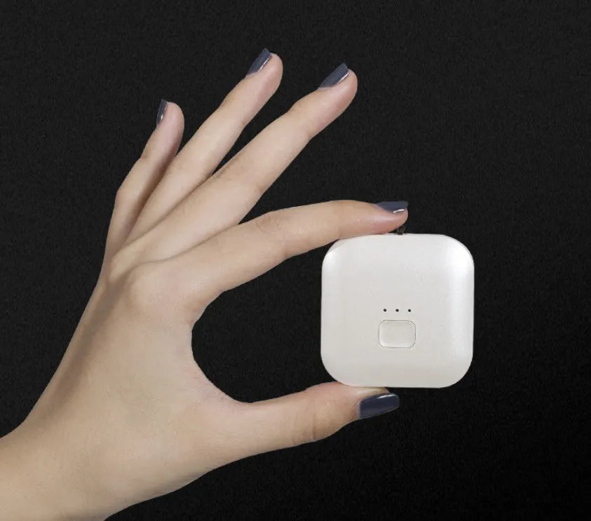 Mini USB portable air purifier necklace in pink, showing compact wearable design.