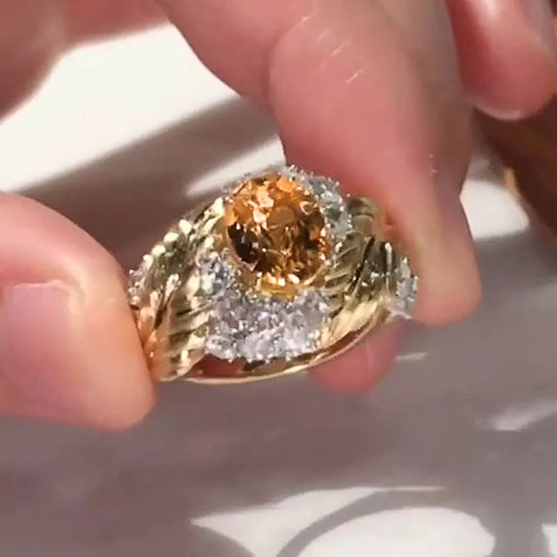 Gold-coloured embossed feather ring with geometric shape and zircon inlay, shown in women's fashion jewellery style