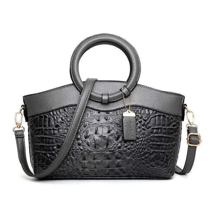 Fabric fashion handbag showing zippered compartments including mobile phone and ID pockets