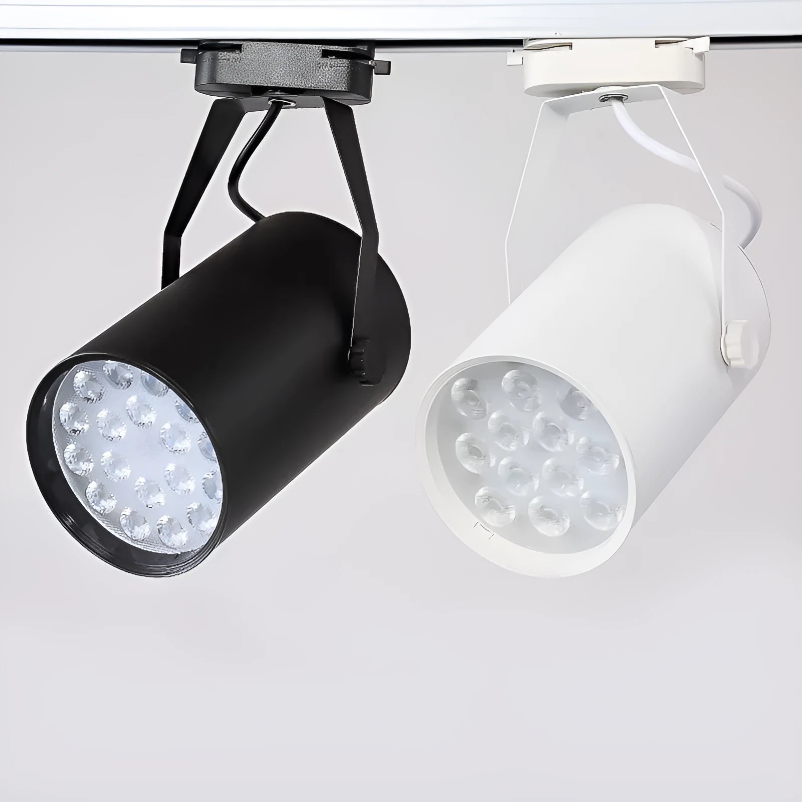 Black and white aluminium shell LED track spotlight mounted on a lighting track for display use.