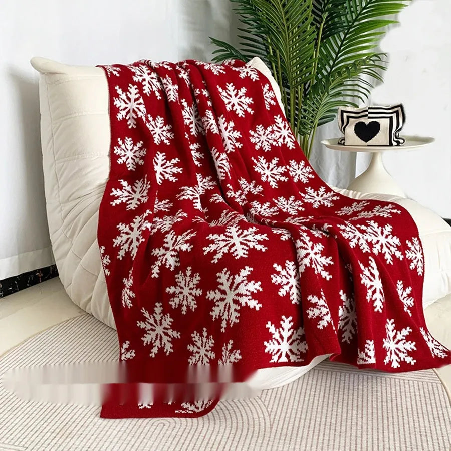 Personalised Christmas acrylic blanket with reindeer or snowflake pattern on a sofa