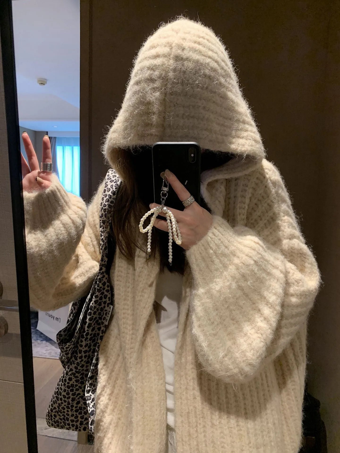Women's dark grey retro Maillard knit hooded cardigan on a hanger, showing loose fit and regular sleeves.