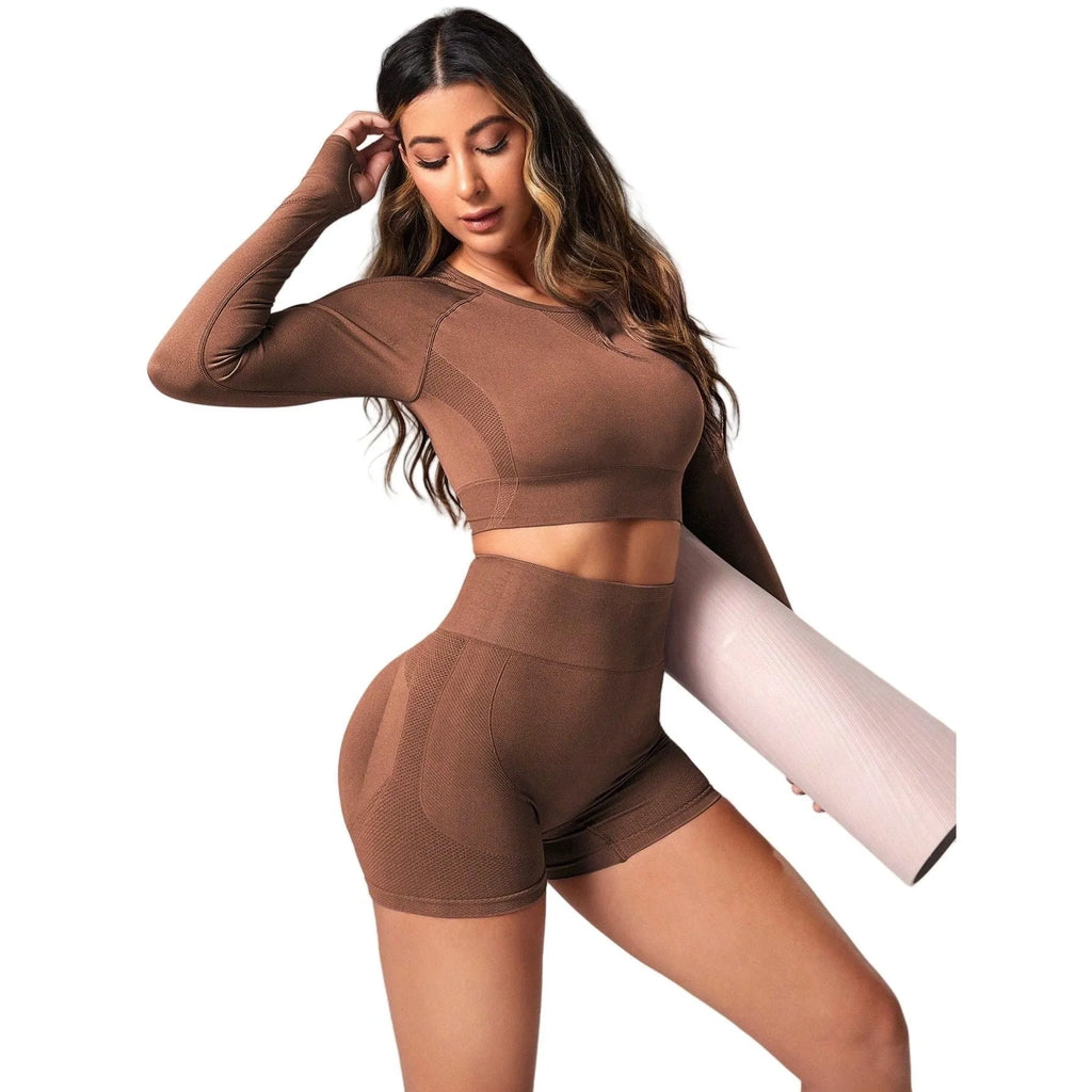 Women's yoga suit set in black colour showing high-waist pants and long sleeve pullover top