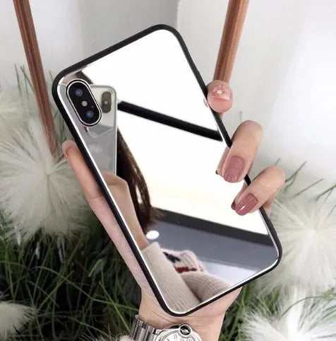 Black mirror iPhone back cover case for iPhone 7 Plus, 8 Plus, and X models on a table.