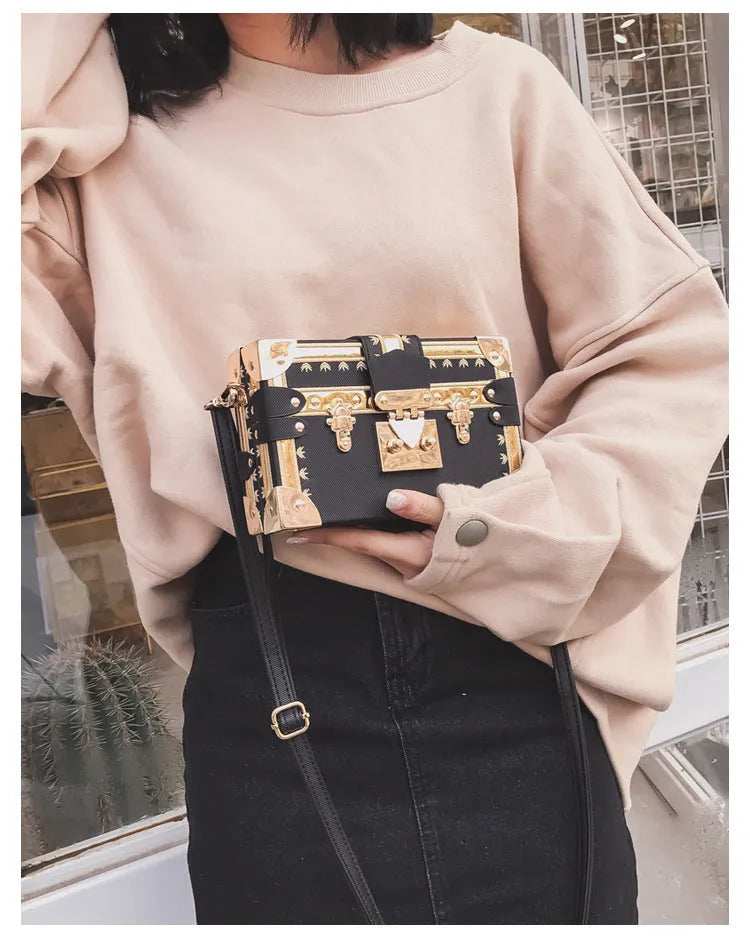 Women's structured shoulder bag with flap closure and adjustable crossbody strap in black or green