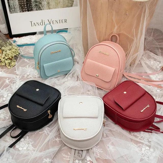 Solid colour PU leather women's small shoulder backpack with zipper, shown in available colours.