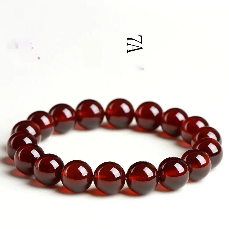 Natural orange red garnet crystal bracelet with Ruyi design elements on wrist