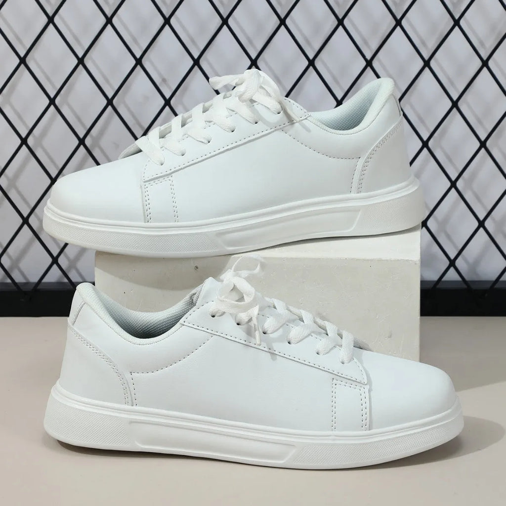 Women's beige brown platform skate sneakers with cross-strap detail and chunky rubber sole.