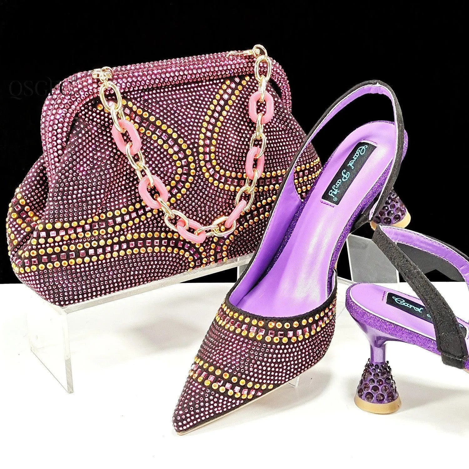 Women's pink pointed toe high heel shoes with rhinestones and a matching small clutch bag.