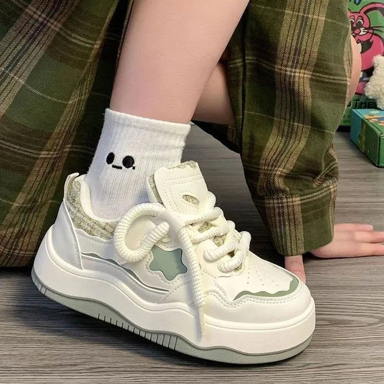 Green women's platform sneakers with patent leather finish, round toe, and white rubber sole.