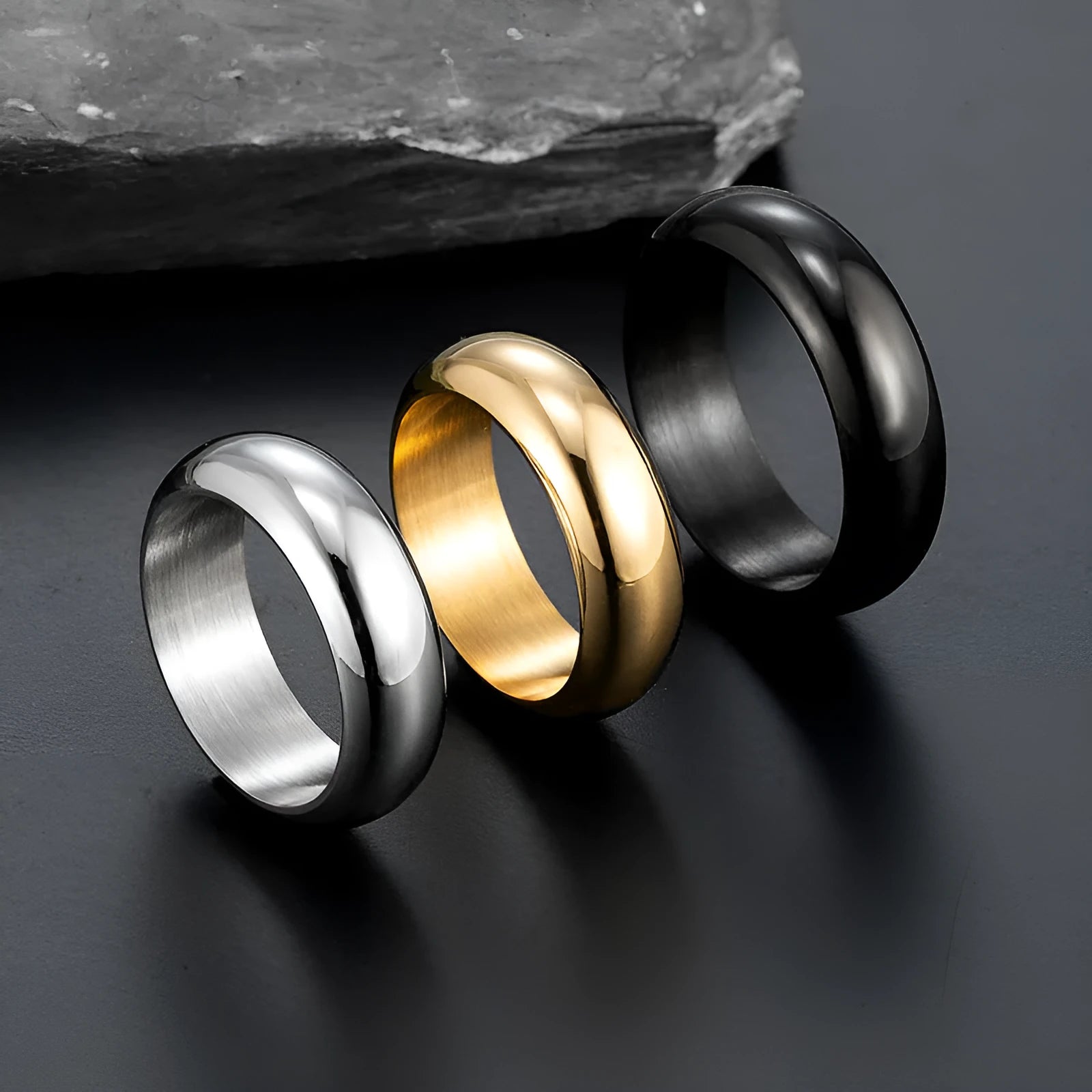 Glossy electroplated titanium steel ring in gold, black, and steel colours showing band detail
