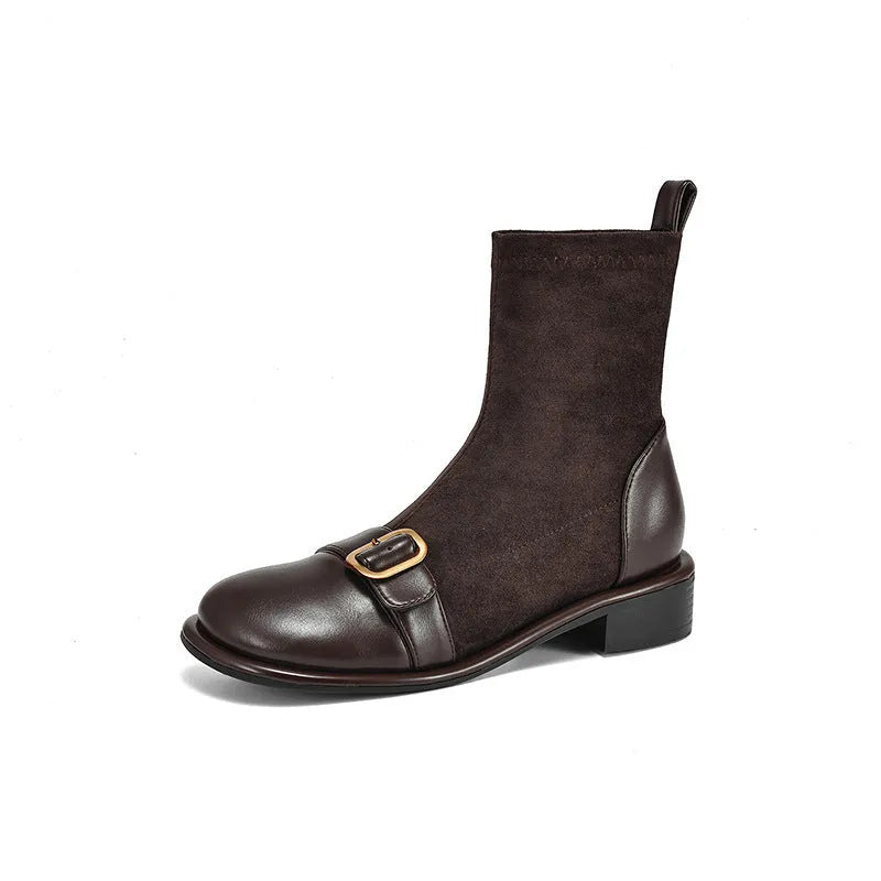 Women's black low heel Martin boots with belt buckle stitching and front lace-up closure on a round toe.