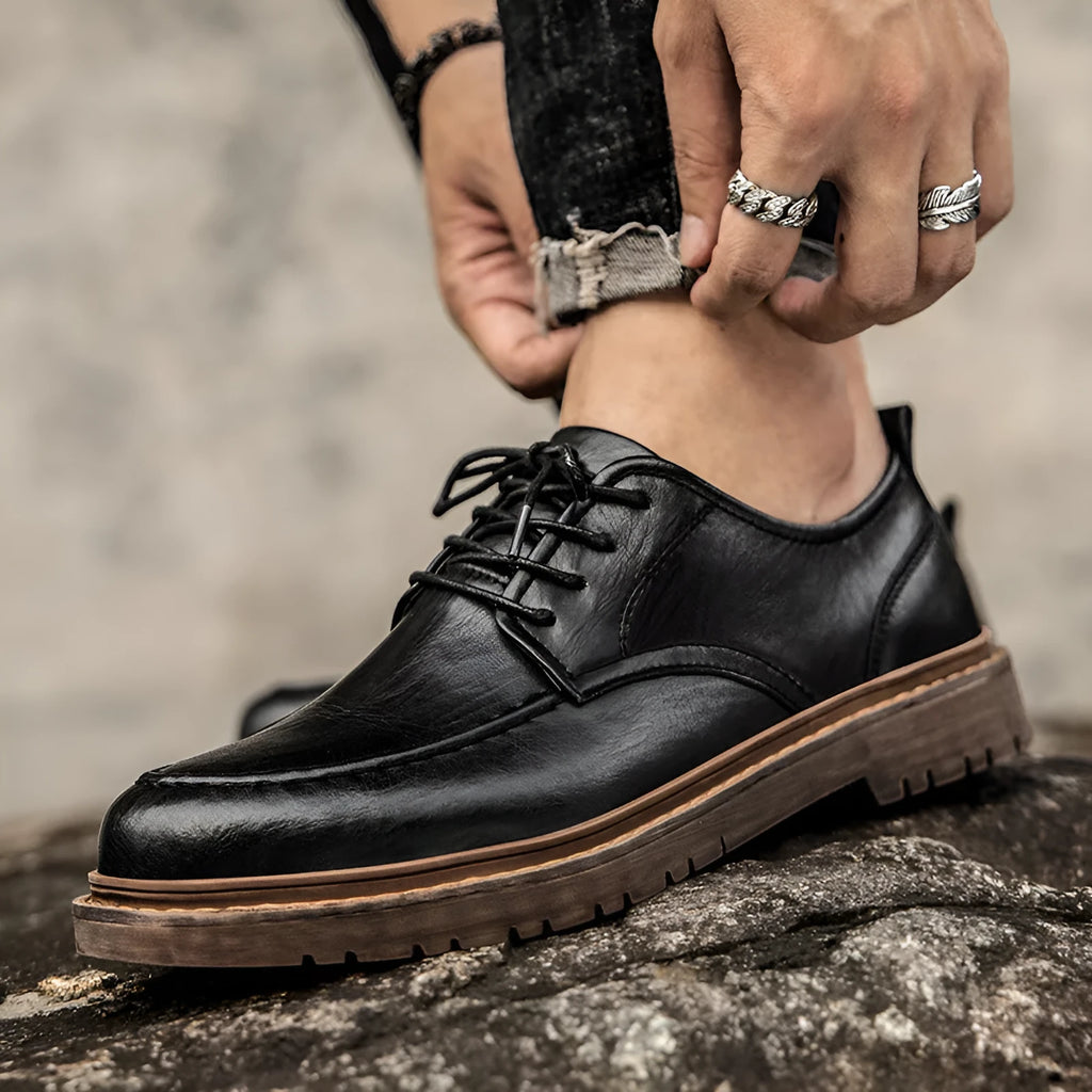 Men's black and brown casual leather shoes with round toe and flat rubber sole.