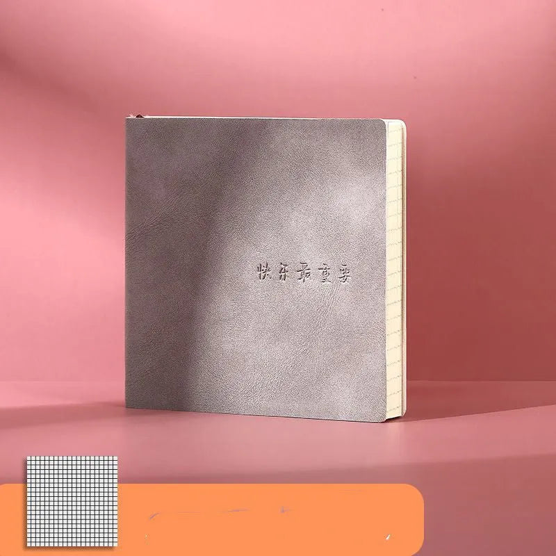 Square A5 mesh leather notebook in avocado green with French fold binding open on blank pages