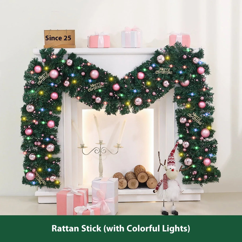 Pink Christmas rattan garland with small fruit details and LED lights draped across doorway