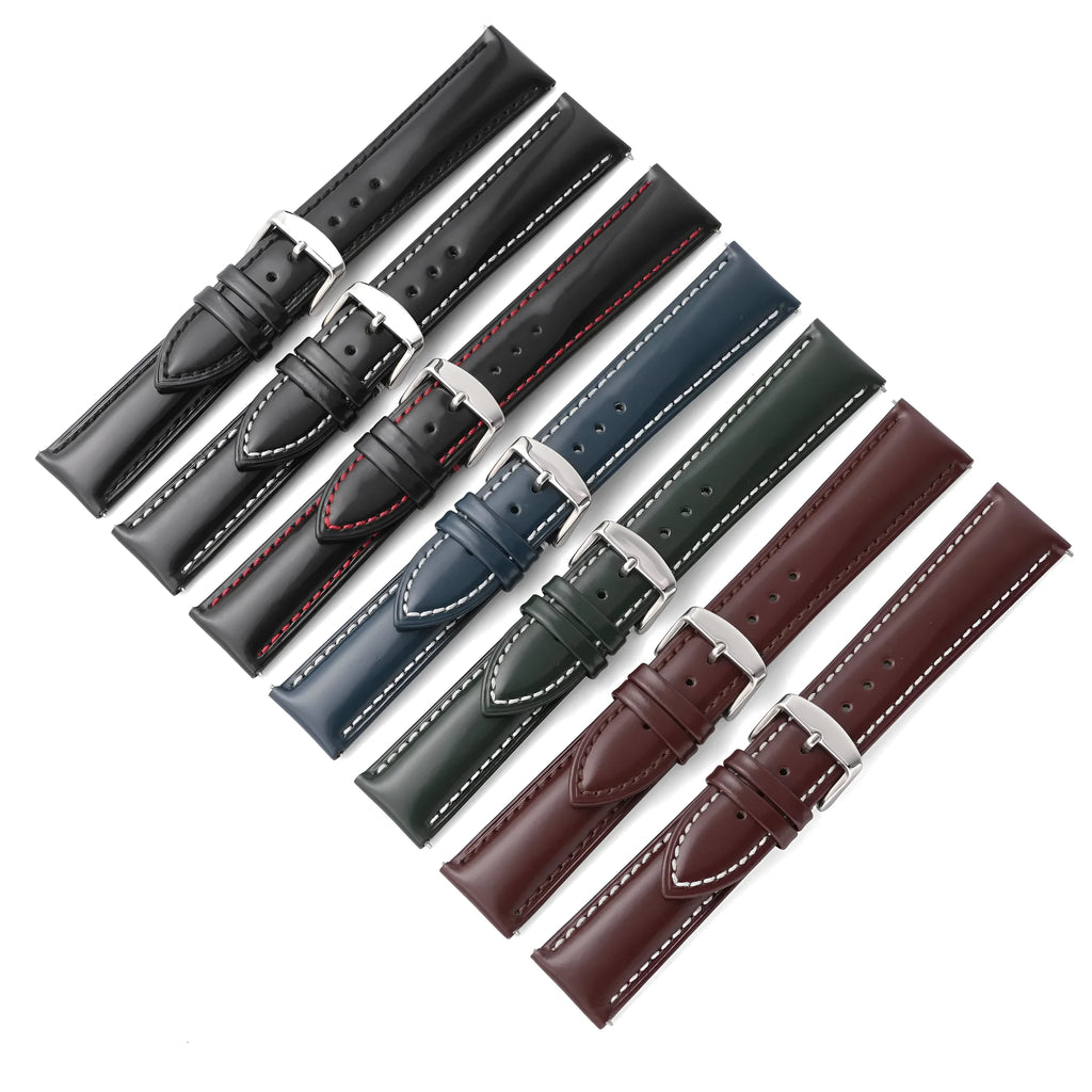 Quick-release cowhide leather watch strap in black with white accent line, showing the spring bar mechanism.