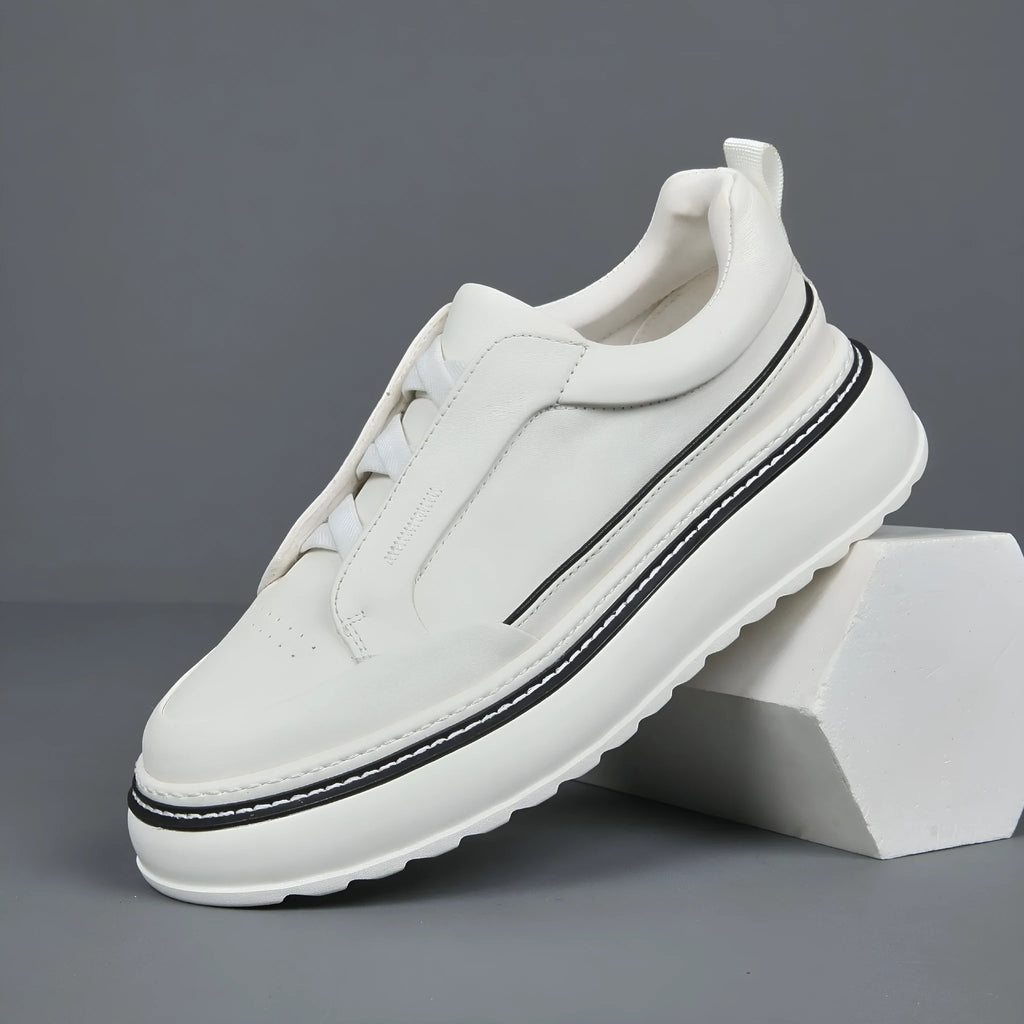 Black leather low-top slip-on sneaker with elastic sides and foam sole on white background