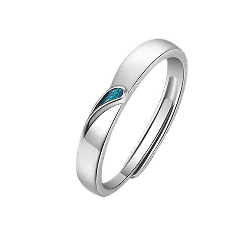 Blue tear drop copper ring with water drop shape and glue-drip finish on a dark background