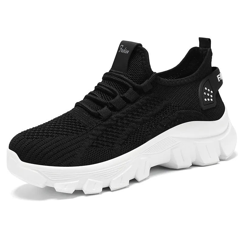 Women's white Flyknit sneakers with a thick PVC sole and front lace-up on a plain background.