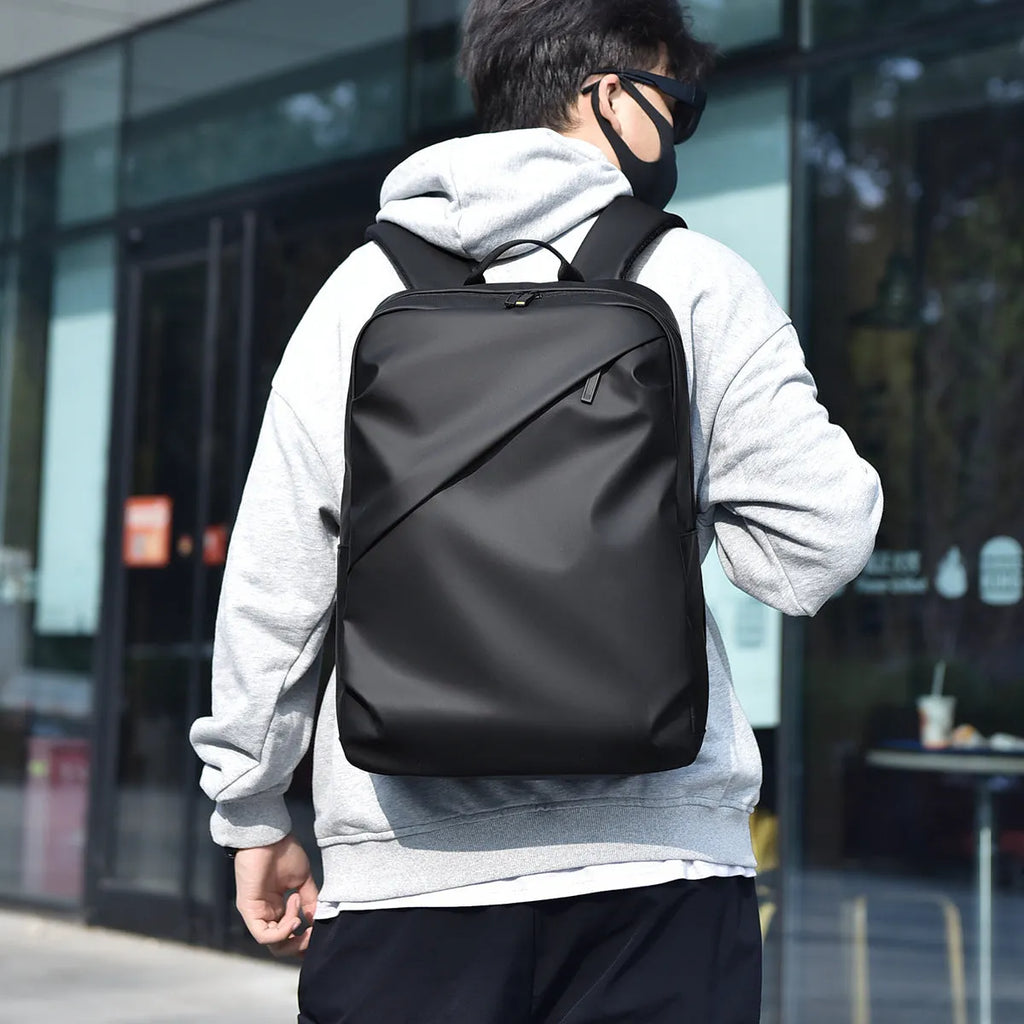 Large black waterproof PU leather backpack for men with sewing thread detailing and computer bag