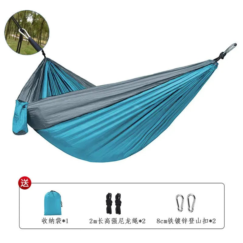 Blue parachute cloth nylon camping hammock shown hung between trees with 270cm length