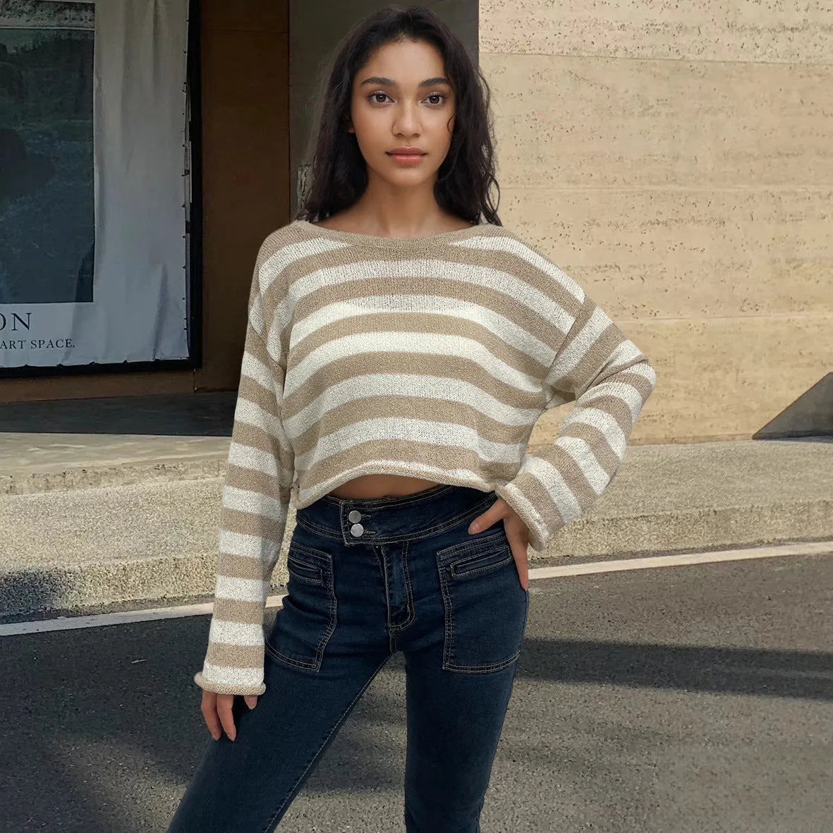 Women's black and white striped cropped long sleeve sweater made from mercerised cotton on a model.