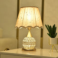 Gold crystal desk lamp with iron art base on a wooden table