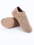 Camel colour dance yoga shoes with cotton mesh upper and leather sole on a plain background.