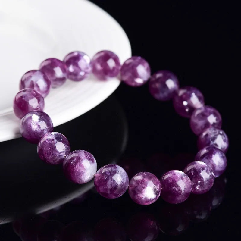 Grandmother Crystal bracelet with purple geometry-shaped beads on a wrist.
