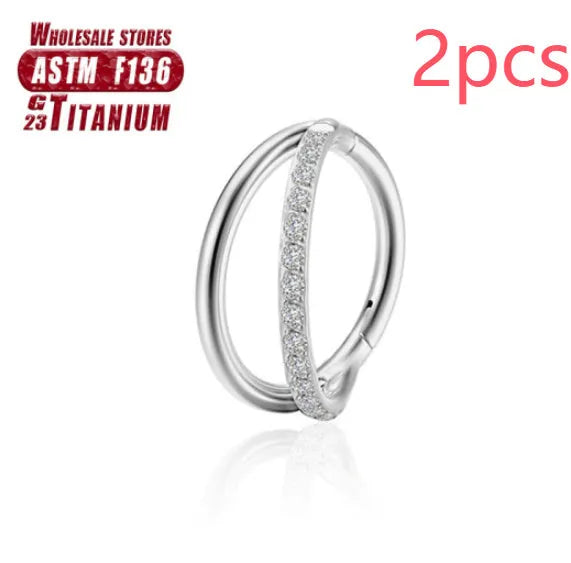 Titanium alloy nose ring on a plain background, shown in silver and gold finishes.
