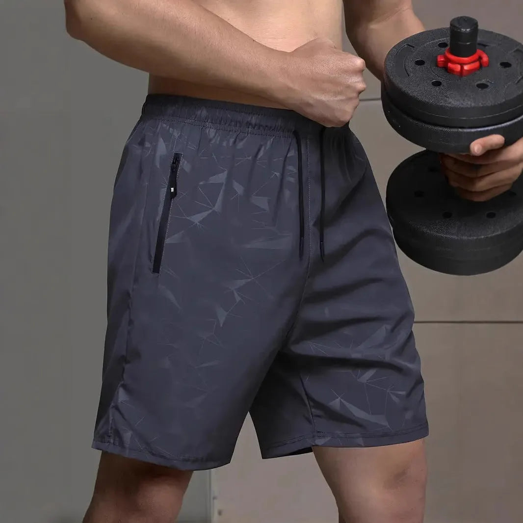 Men's loose grey polyester sports shorts with elastic waistband on a white background