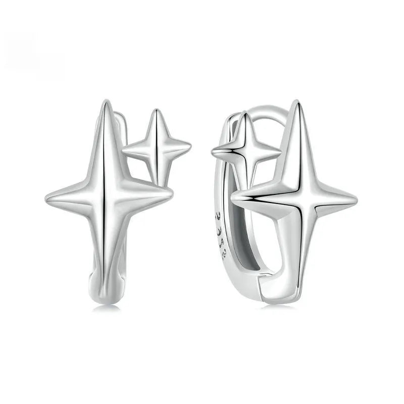 Minimalist oxidised sterling silver star ear clip with XINGX detail on a white background.