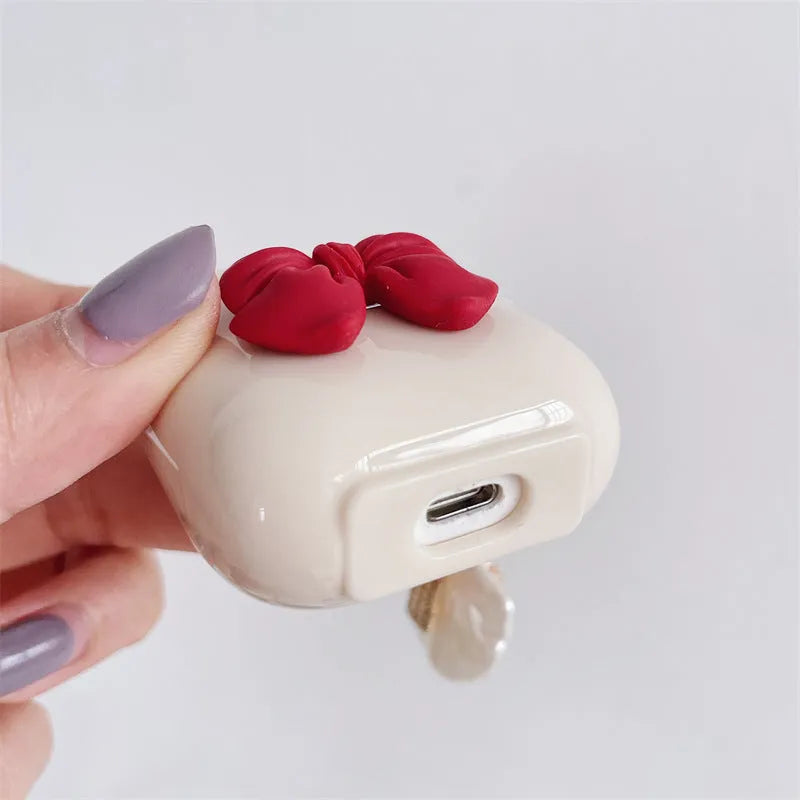 Beige and red bow shell design TPU silicone protective case for AirPods Pro charging case.
