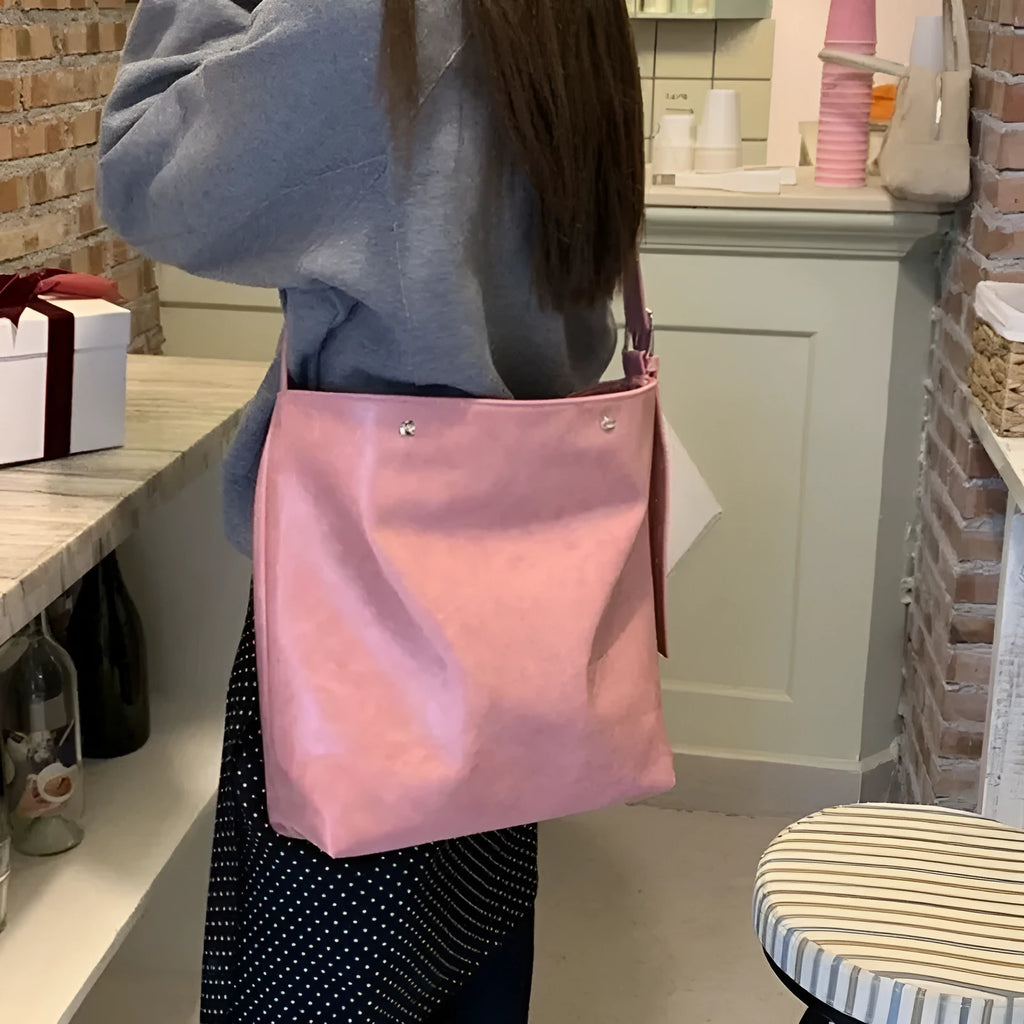 Pink corduroy one-shoulder commuter bag with a single strap and PU lining.