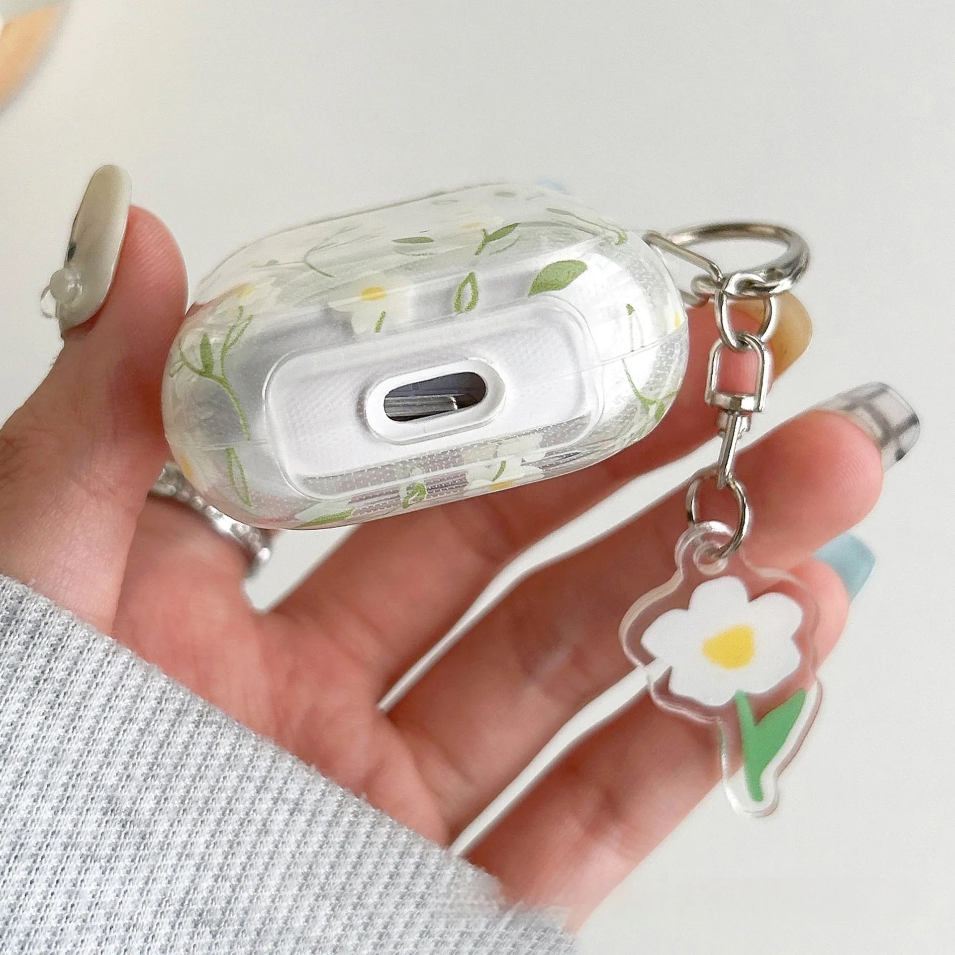White floral transparent TPU protective case for Apple AirPods charging case.