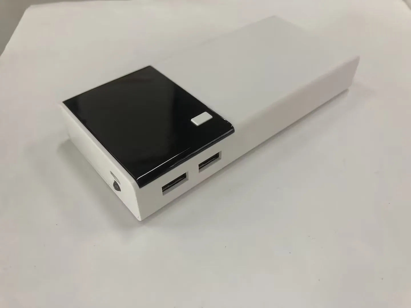 Black 20000mAh power bank with plastic casing and charging cable