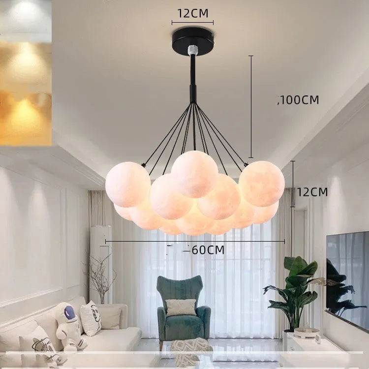 Nordic fish-shaped pendant chandelier with cluster of spherical moon bubble lights in gold or black finish.