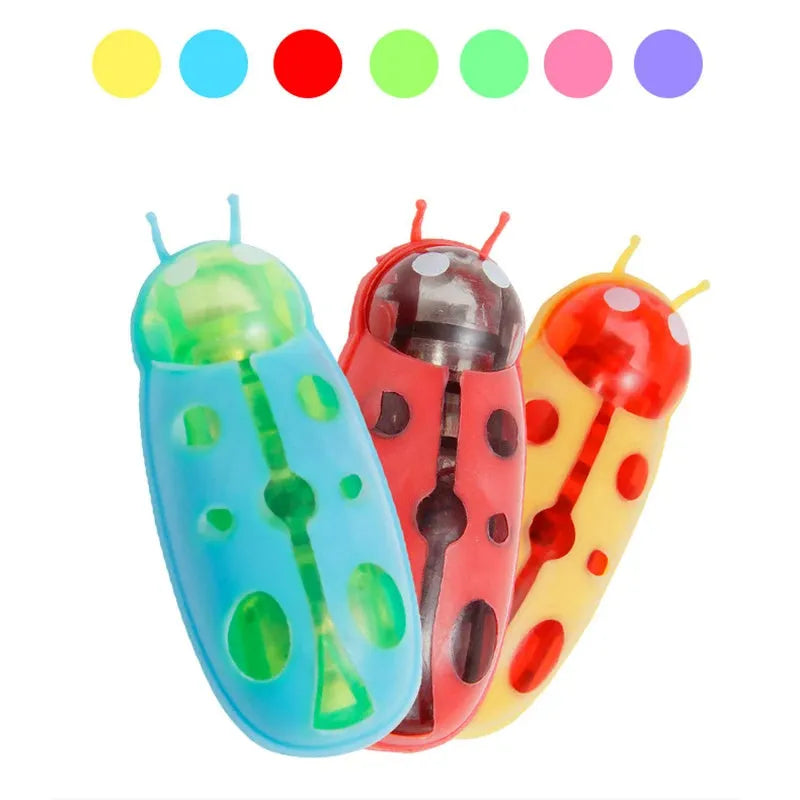Miniature electric ladybird beetle cat toy on floor showing size and insect shape