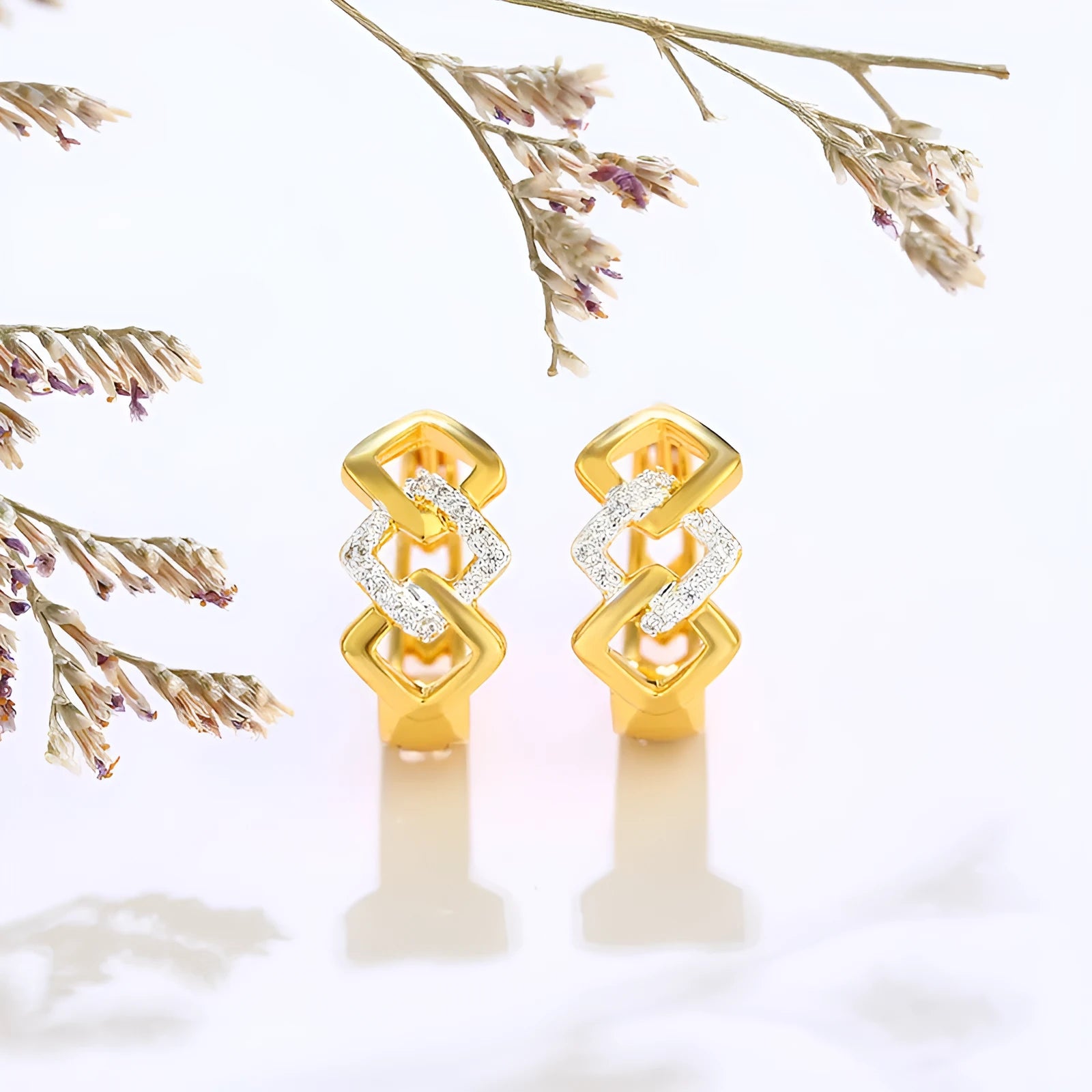 Gold geometric hollow out earrings with electroplated finish at ear clip area